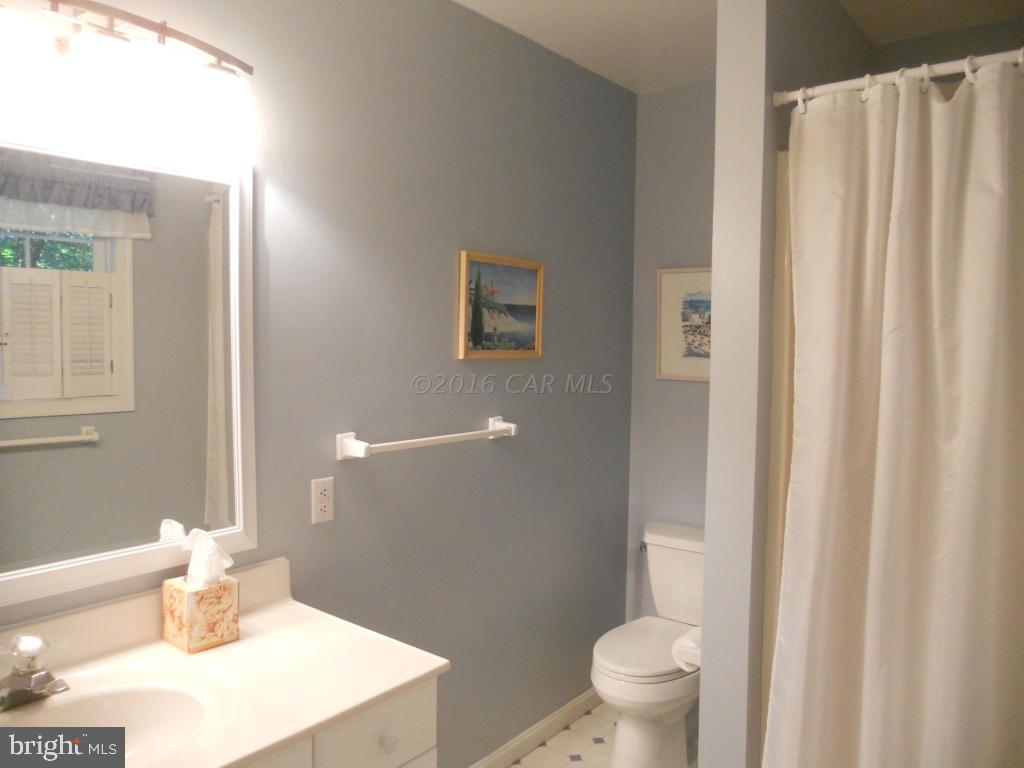 21 Rabbit Run Lane Ocean Pines, MD 21811 - Photo 11 of 22 a bathroom with a sink toilet and shower