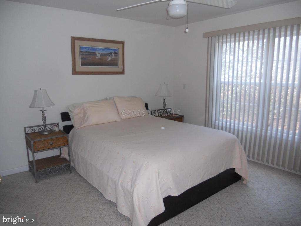 21 Rabbit Run Lane Ocean Pines, MD 21811 - Photo 12 of 22 a bed sitting in a bedroom next to a window