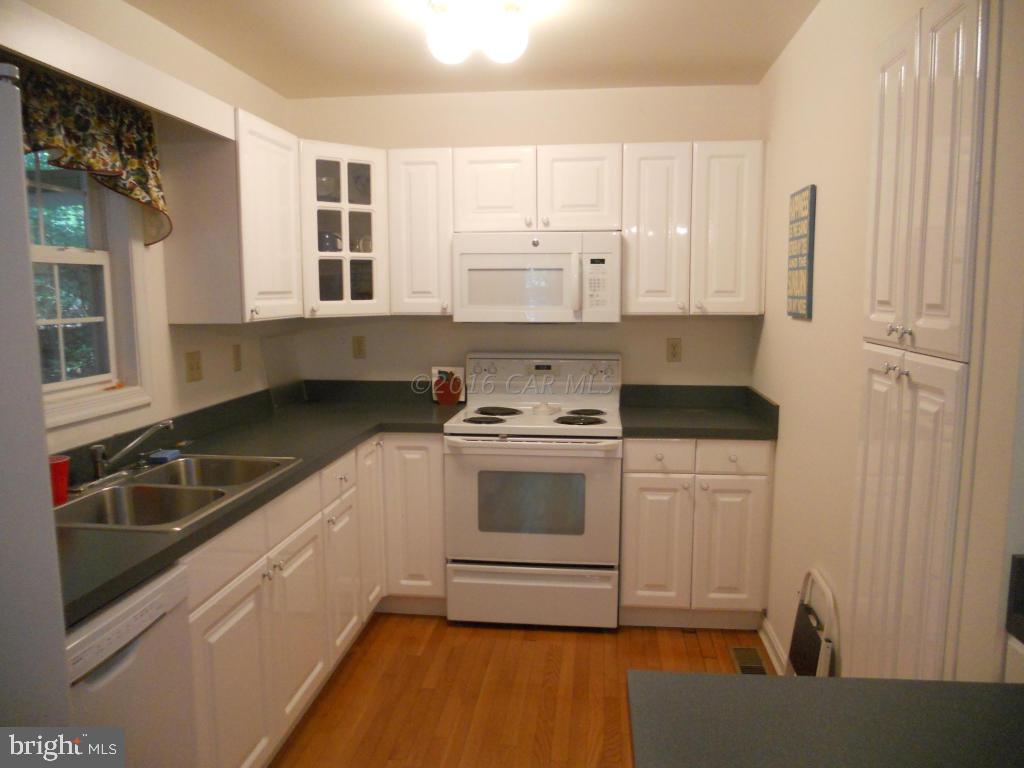 21 Rabbit Run Lane Ocean Pines, MD 21811 - Photo 3 of 22 a kitchen with granite countertop white cabinets and white appliances