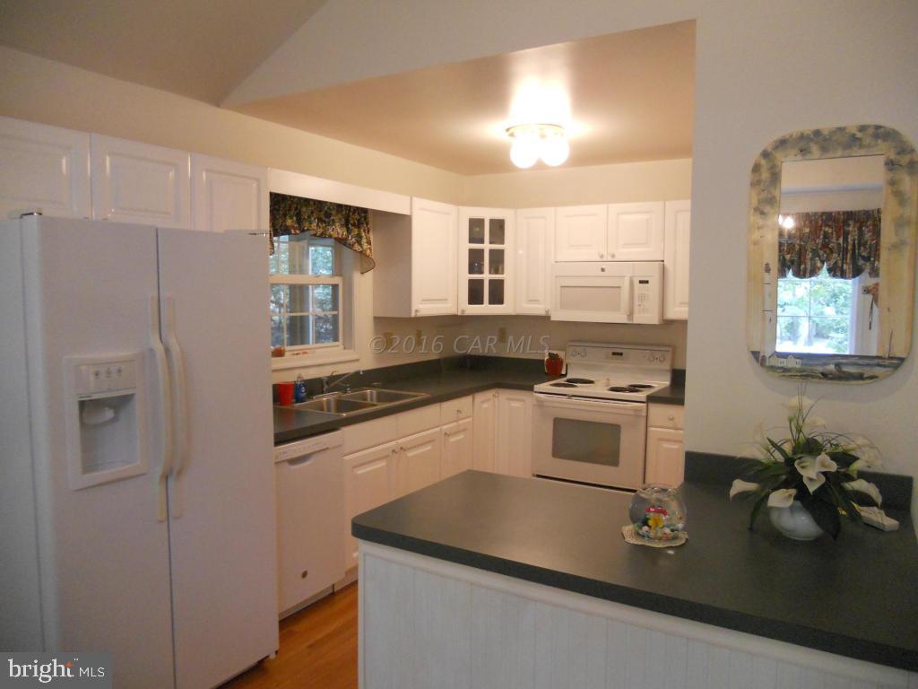 21 Rabbit Run Lane Ocean Pines, MD 21811 - Photo 4 of 22 a kitchen with stainless steel appliances granite countertop a stove a sink and a refrigerator