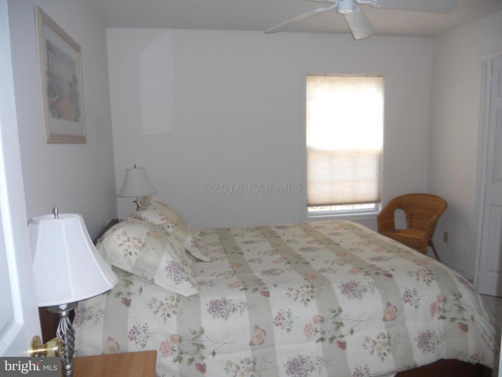 21 Rabbit Run Lane Ocean Pines, MD 21811 - Photo 10 of 22 a bedroom with a bed and a window