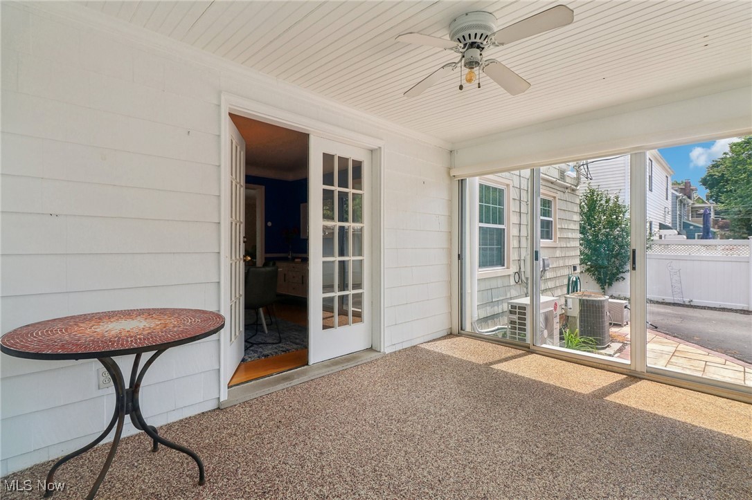 3320 Avalon Road Cleveland, OH 44120 - Photo 10 of 28 3 Season sunroom off dining room featuring nature stone flooring and a ceiling fan