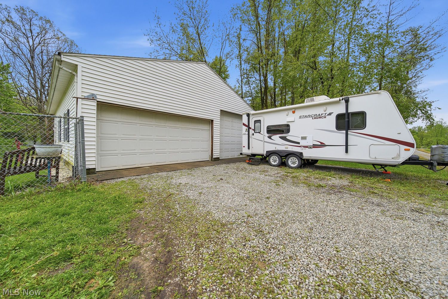 1556 Koons Road North Canton, OH 44720 - Photo 7 of 30 Oversized extra-deep detached garage with ample space for vehicles, storage, workshop space, hobbies, and recreational equipment — easily accommodating larger vehicles, outdoor toys, or additional storage needs.
