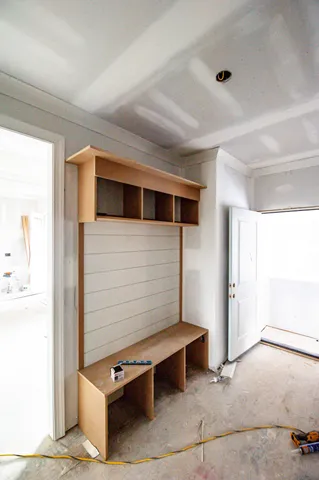 a view of hallway with stairs and wooden floor
