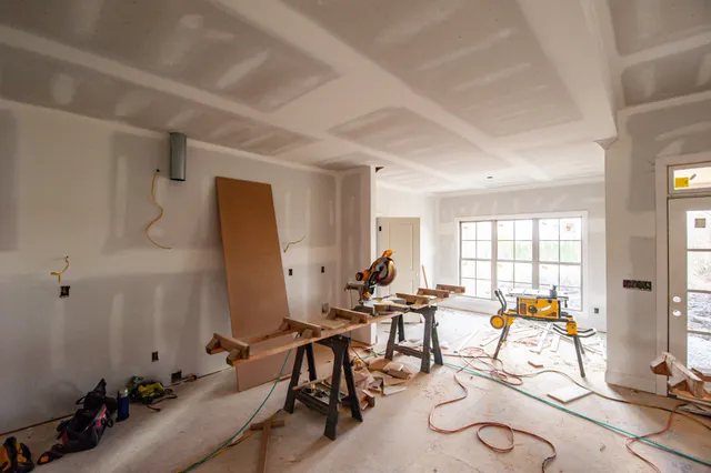 a room with gym equipment and large windows