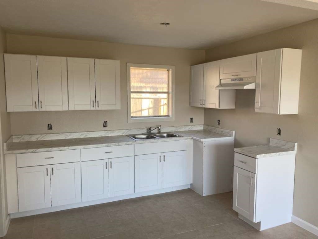 609 West 6th Street Sweeny, TX 77480 - Photo 4 of 12 a kitchen with sink and cabinets