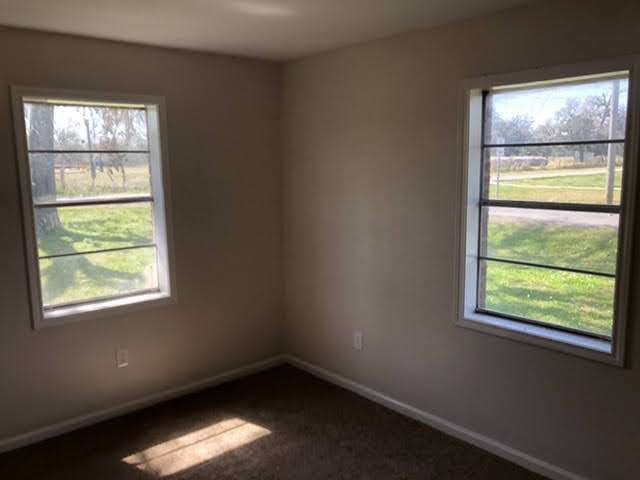 609 West 6th Street Sweeny, TX 77480 - Photo 6 of 12 an empty room with a window