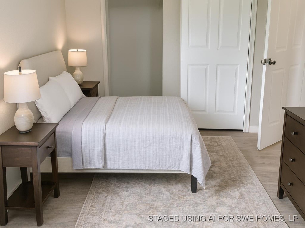 609 West 6th Street Sweeny, TX 77480 - Photo 8 of 12 a bedroom with a bed and a lamp on table