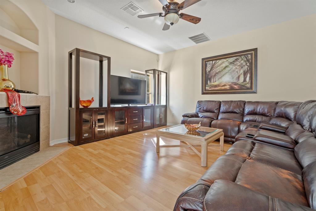 5042 Rishley Run Way Mount Dora, FL 32757 - Photo 16 of 44 a living room with furniture and a flat screen tv