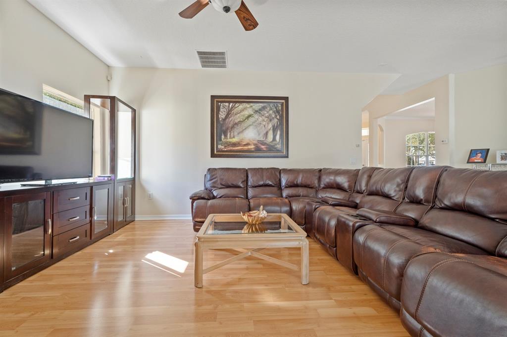 5042 Rishley Run Way Mount Dora, FL 32757 - Photo 17 of 44 a living room with furniture and a flat screen tv