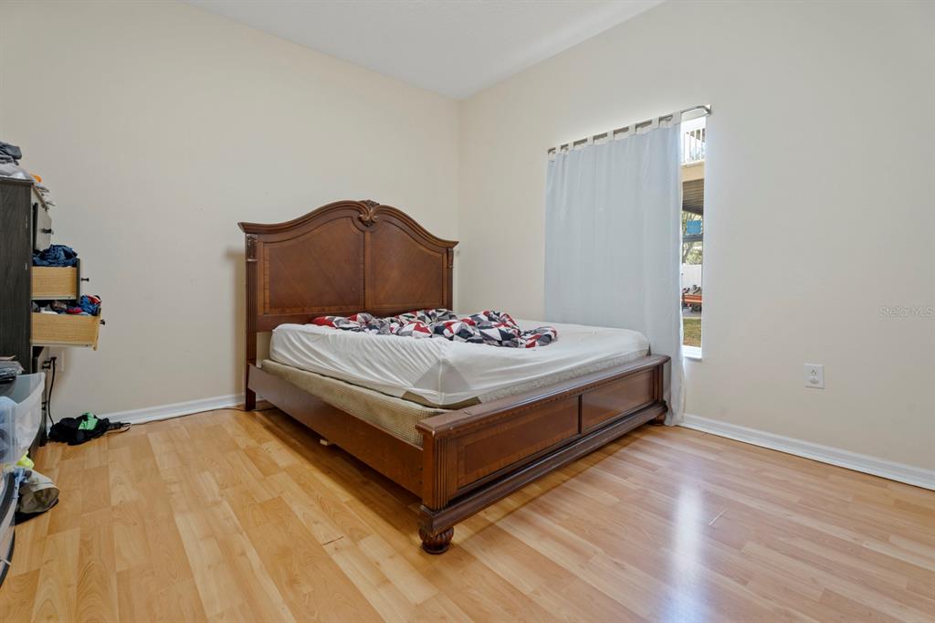 5042 Rishley Run Way Mount Dora, FL 32757 - Photo 21 of 44 a bedroom with a bed and a table
