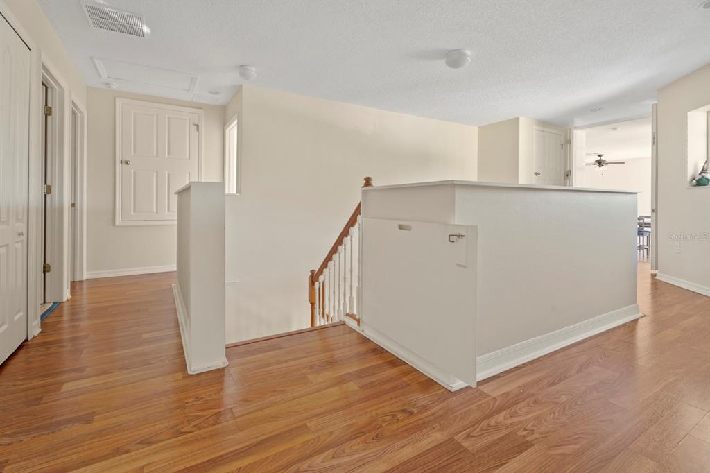 5042 Rishley Run Way Mount Dora, FL 32757 - Photo 22 of 44 a view of a kitchen with wooden floor and staircase