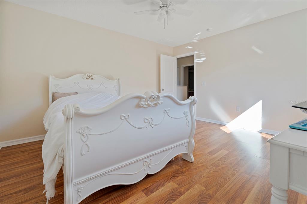 5042 Rishley Run Way Mount Dora, FL 32757 - Photo 26 of 44 a bed sitting in a spacious bedroom next to a window