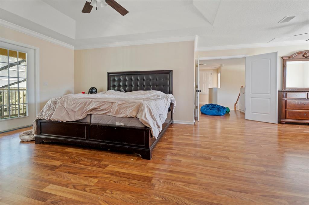5042 Rishley Run Way Mount Dora, FL 32757 - Photo 28 of 44 a bedroom with a bed and wooden floor