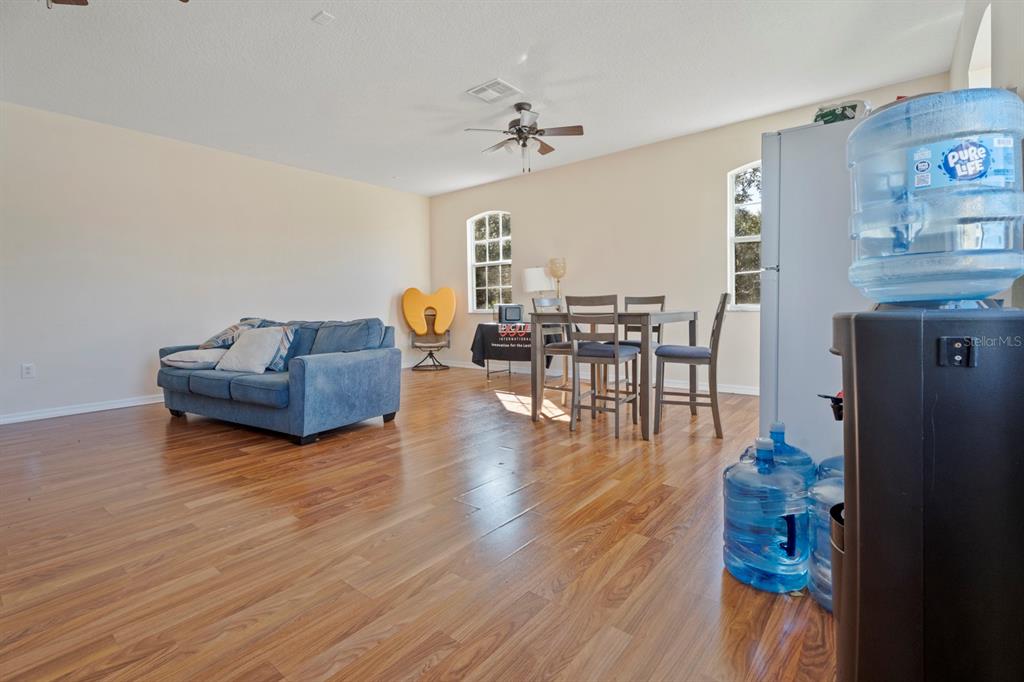 5042 Rishley Run Way Mount Dora, FL 32757 - Photo 33 of 44 a living room with furniture and a wooden floor