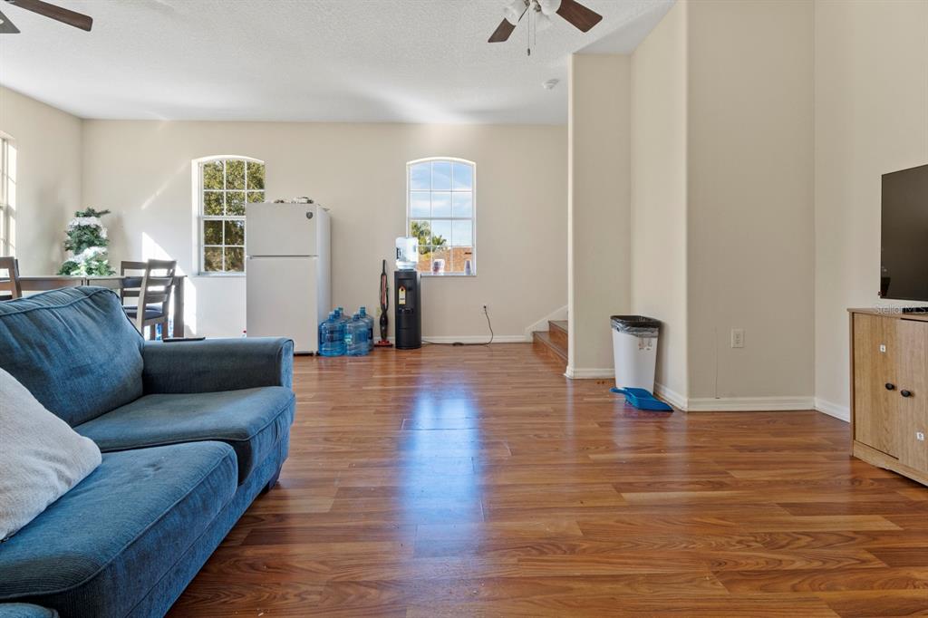 5042 Rishley Run Way Mount Dora, FL 32757 - Photo 35 of 44 a living room with furniture and a wooden floor