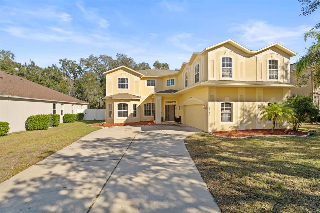 5042 Rishley Run Way Mount Dora, FL 32757 - Photo 4 of 44 a front view of a house with a yard
