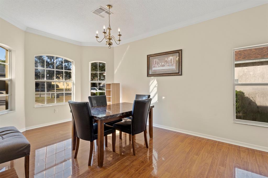 5042 Rishley Run Way Mount Dora, FL 32757 - Photo 9 of 44 a view of a dining room with furniture window and wooden floor