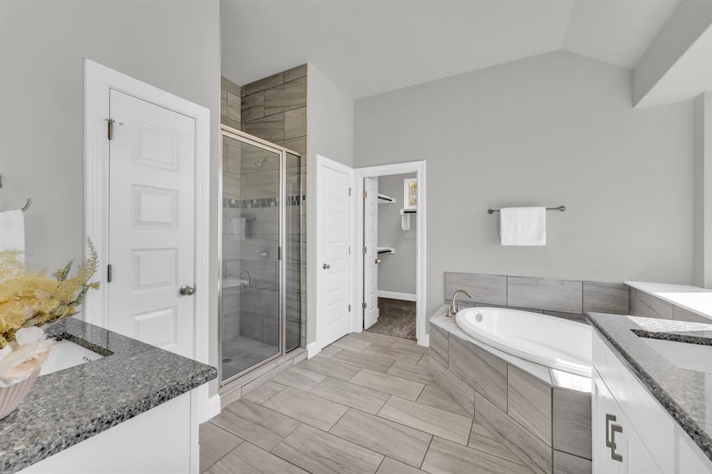 110 Magona Trail Georgetown, TX 78628 - Photo 32 of 38 Luxurious bathroom retreat, offering both a rejuvenating soaking tub and a sleek, glass-enclosed shower.