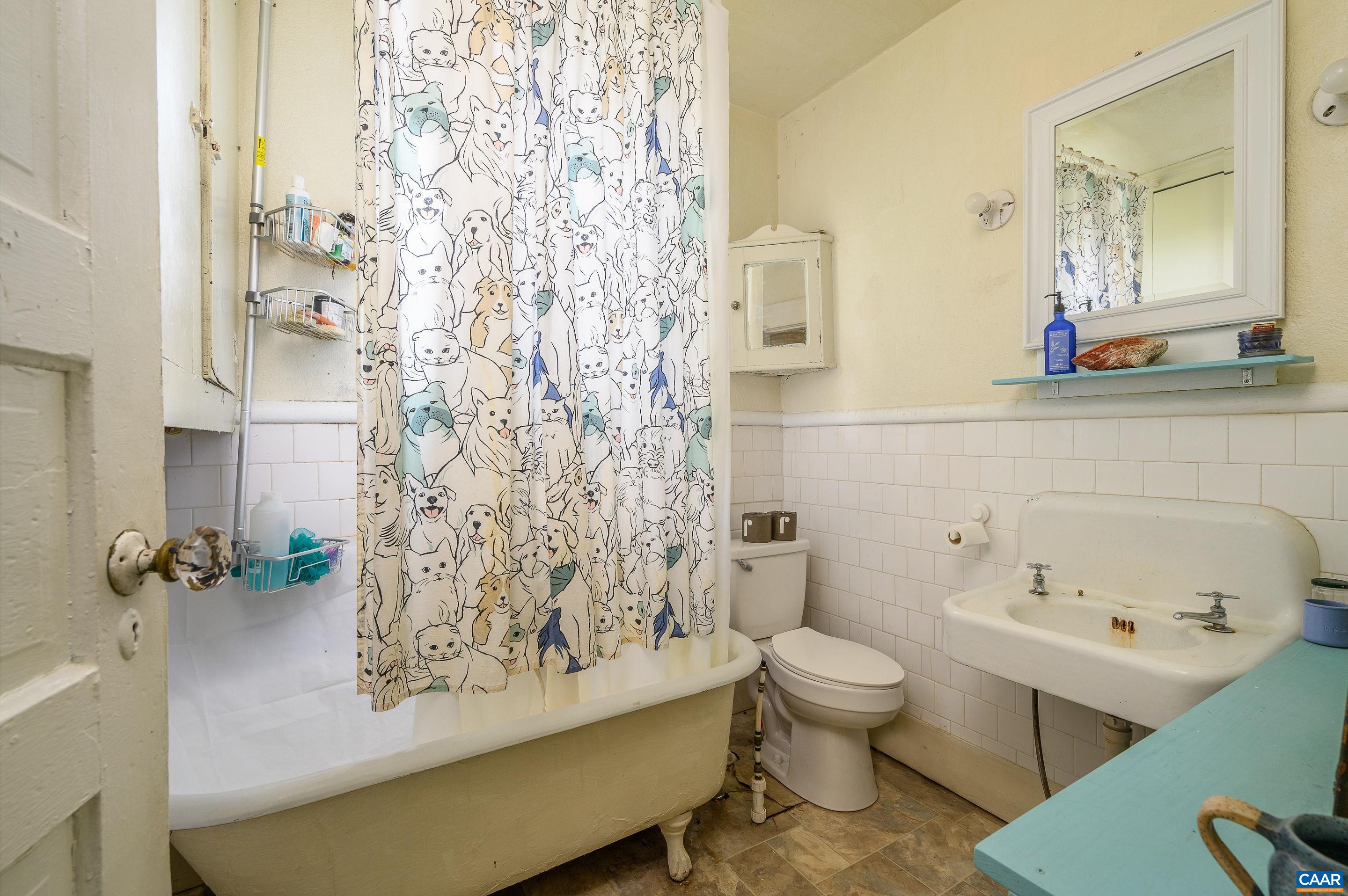 712 Ridge Street Charlottesville, VA 22902 - Photo 12 of 16 a bathroom with a sink toilet mirror and shower
