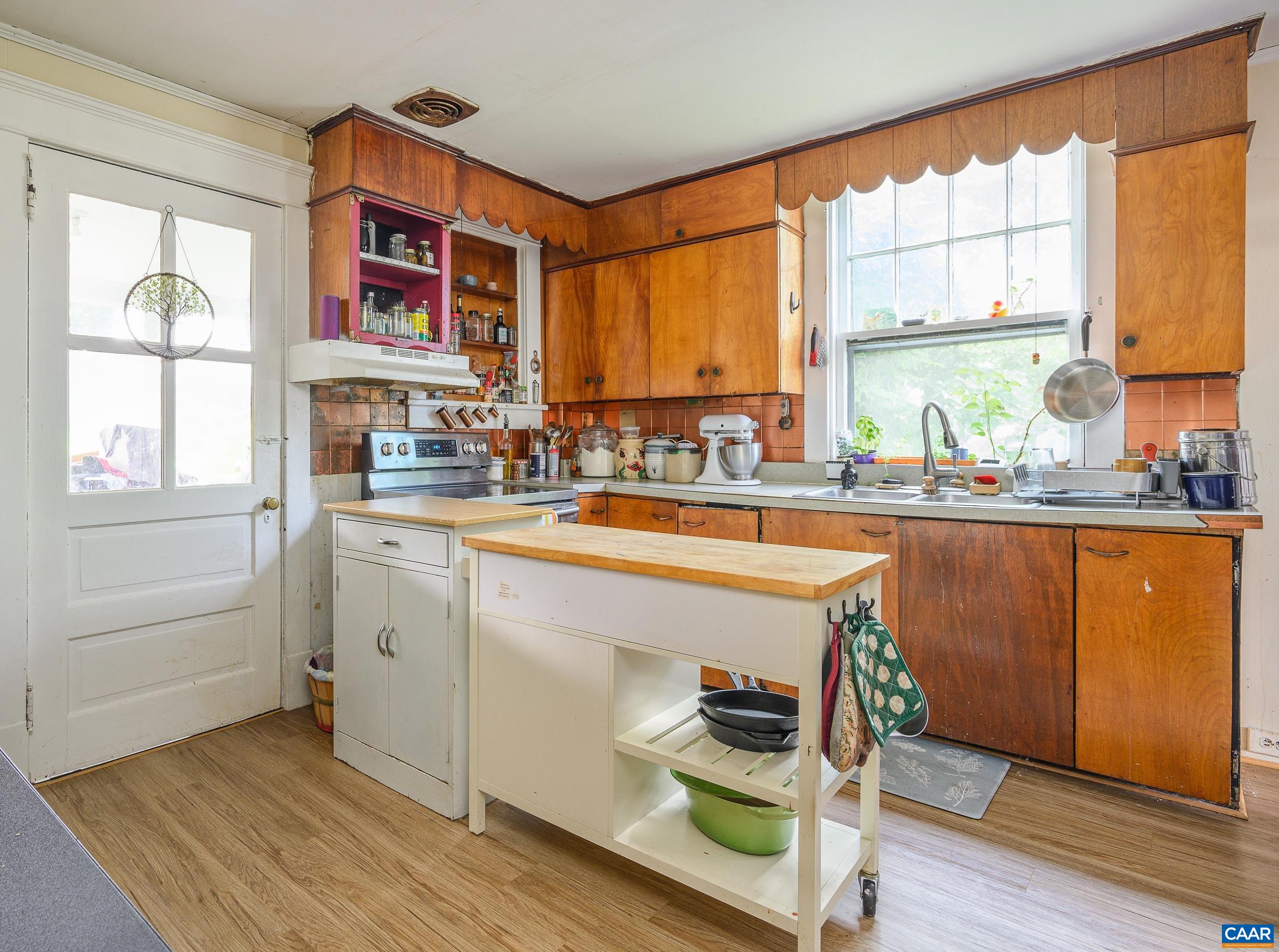 712 Ridge Street Charlottesville, VA 22902 - Photo 8 of 16 a kitchen with sink cabinets and wooden floor