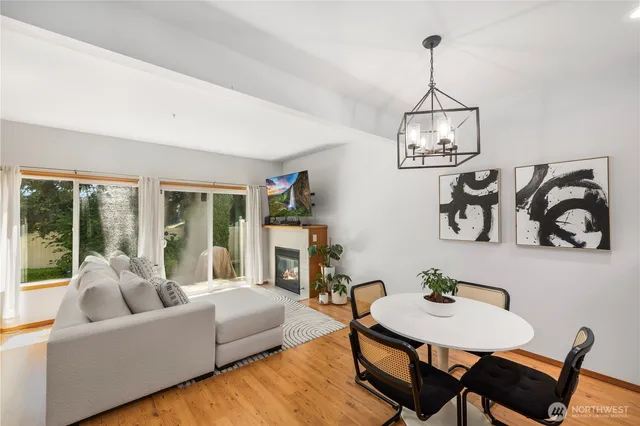 a living room with furniture and a chandelier