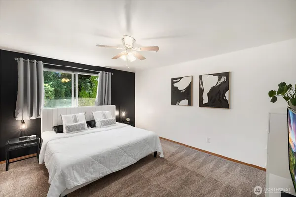 a bedroom with a large bed and a large window