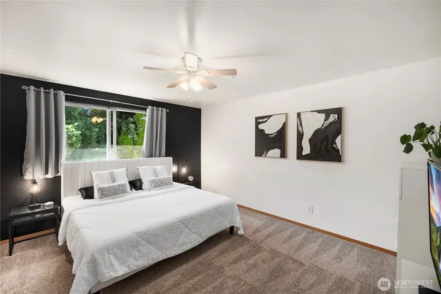 a bedroom with a large bed and a large window