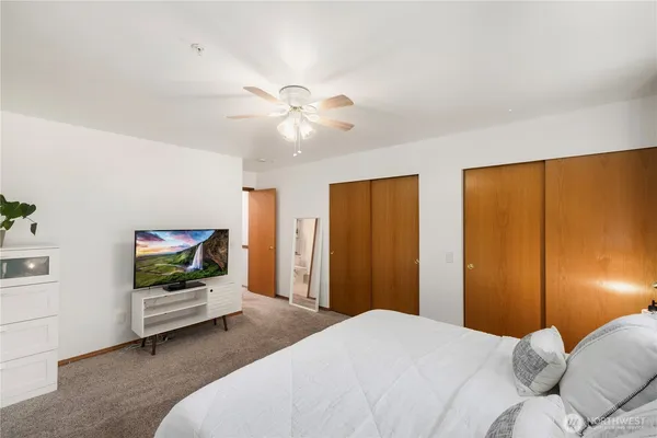 a bedroom with a bed and a flat screen tv