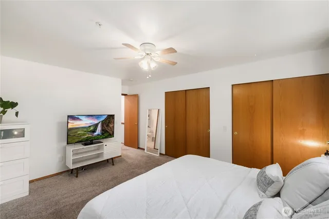 a bedroom with a bed and a flat screen tv