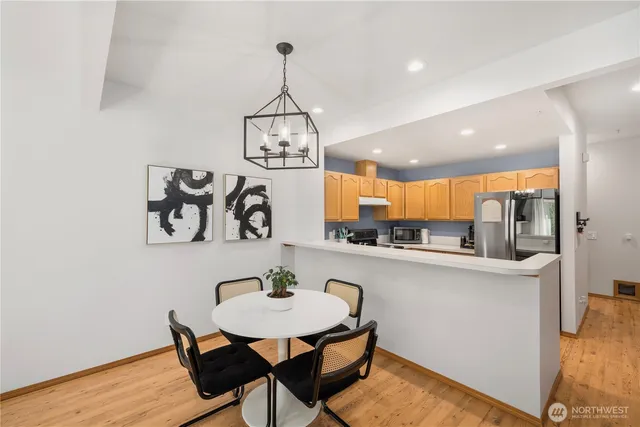 a view of a dining room with furniture and wooden floor