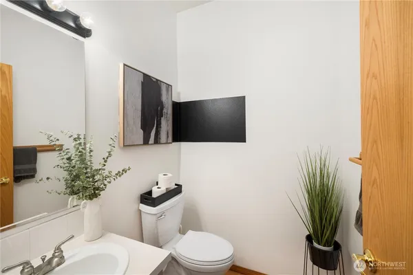a bathroom with a toilet sink and mirror