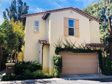 137 Tall Oak Irvine, CA 92603 - Photo 1 of 12 a view of a small house with potted plants and a large tree