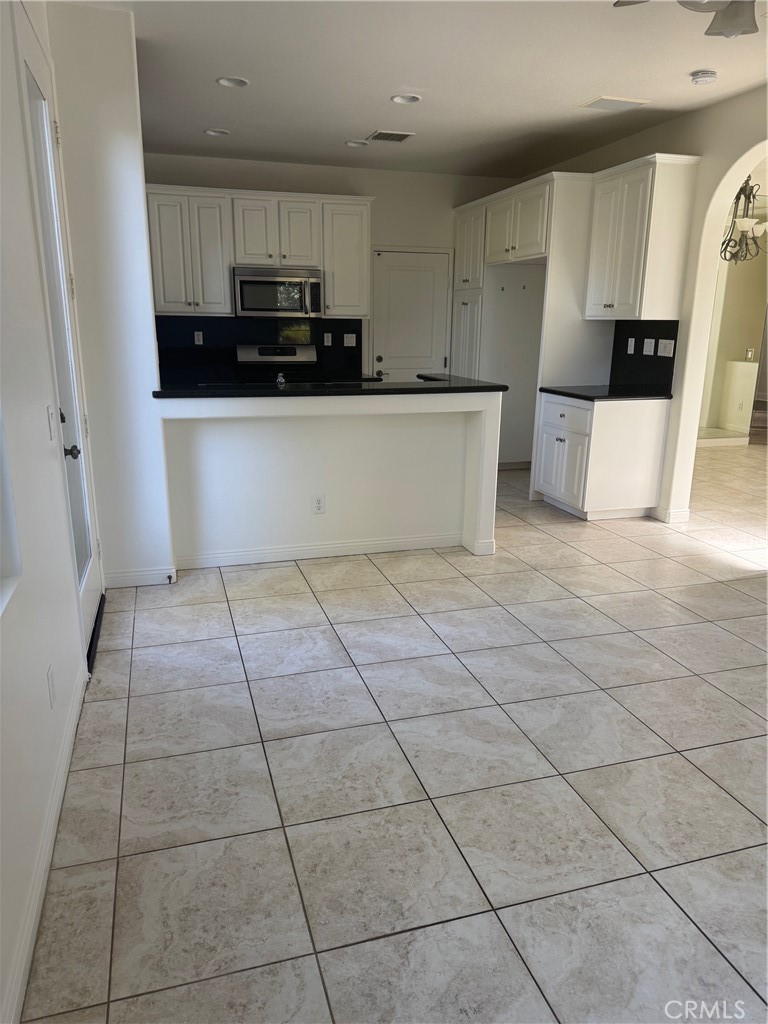 137 Tall Oak Irvine, CA 92603 - Photo 4 of 12 a view of a kitchen with a sink and a stove top oven