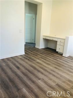 137 Tall Oak Irvine, CA 92603 - Photo 7 of 12 a view of an empty room with wooden floor and cabinet