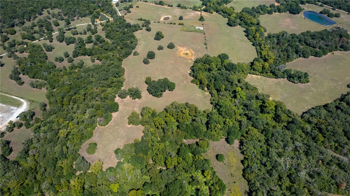 11041 Jackrabbit Lane Bryan, TX 77808 - Photo 33 of 47 an aerial view of a house with a yard and trees