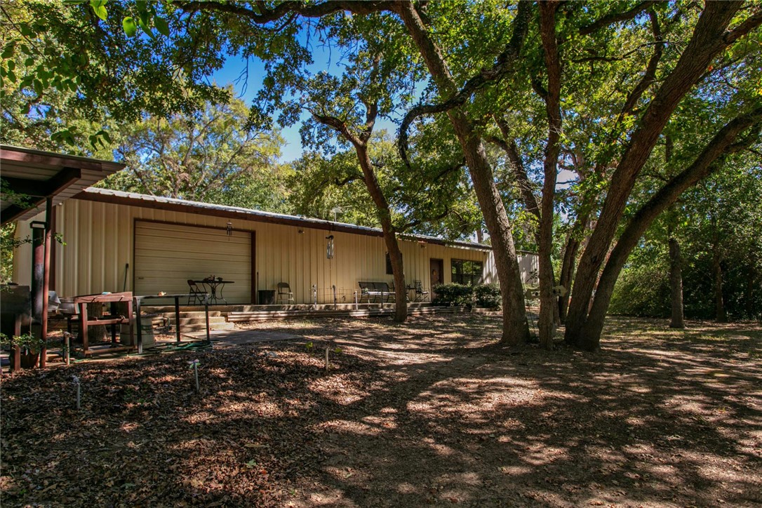 11041 Jackrabbit Lane Bryan, TX 77808 - Photo 7 of 47 a backyard of a house with yard and outdoor seating