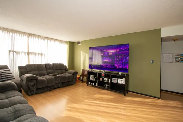a living room with furniture a air conditioner and a window
