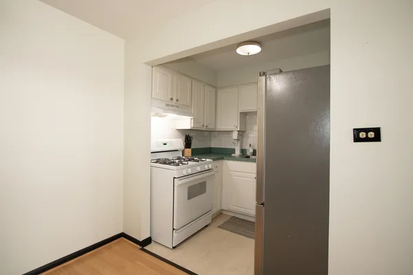 a kitchen with a sink cabinets and stainless steel appliances