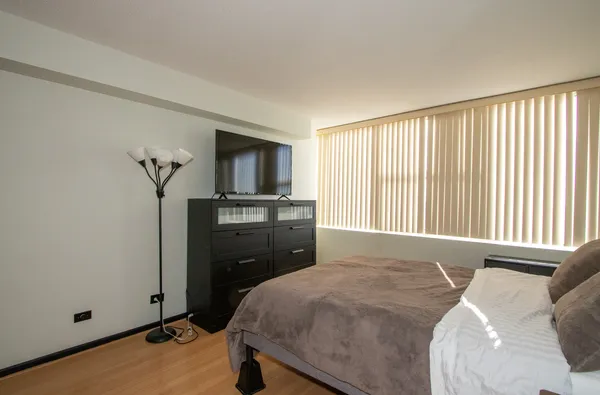 a bed room with a bed and a television
