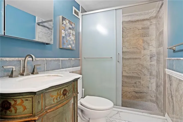 a bedroom with two beds and painting on the wall