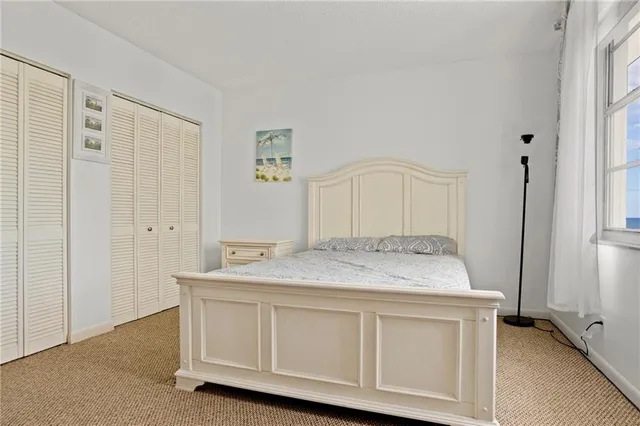 a room with pool table and windows