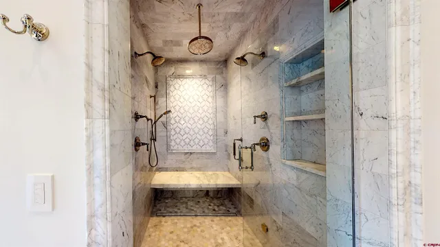 a view of a wooden door with a chair and potted plant