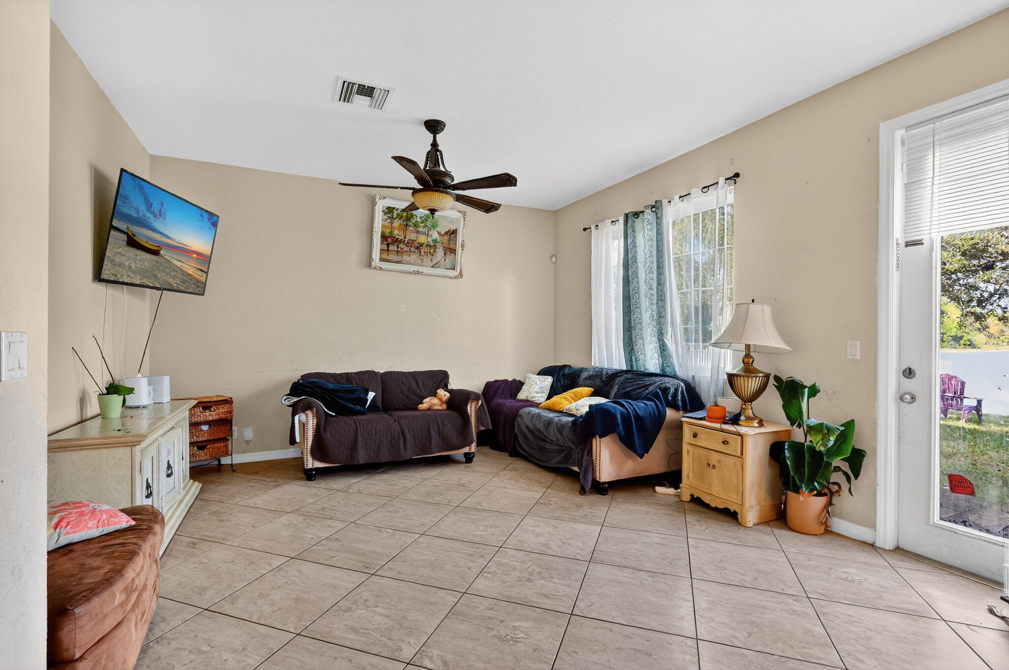 6720 Osage Circle Greenacres, FL 33413 - Photo 12 of 54 a living room with furniture and a window