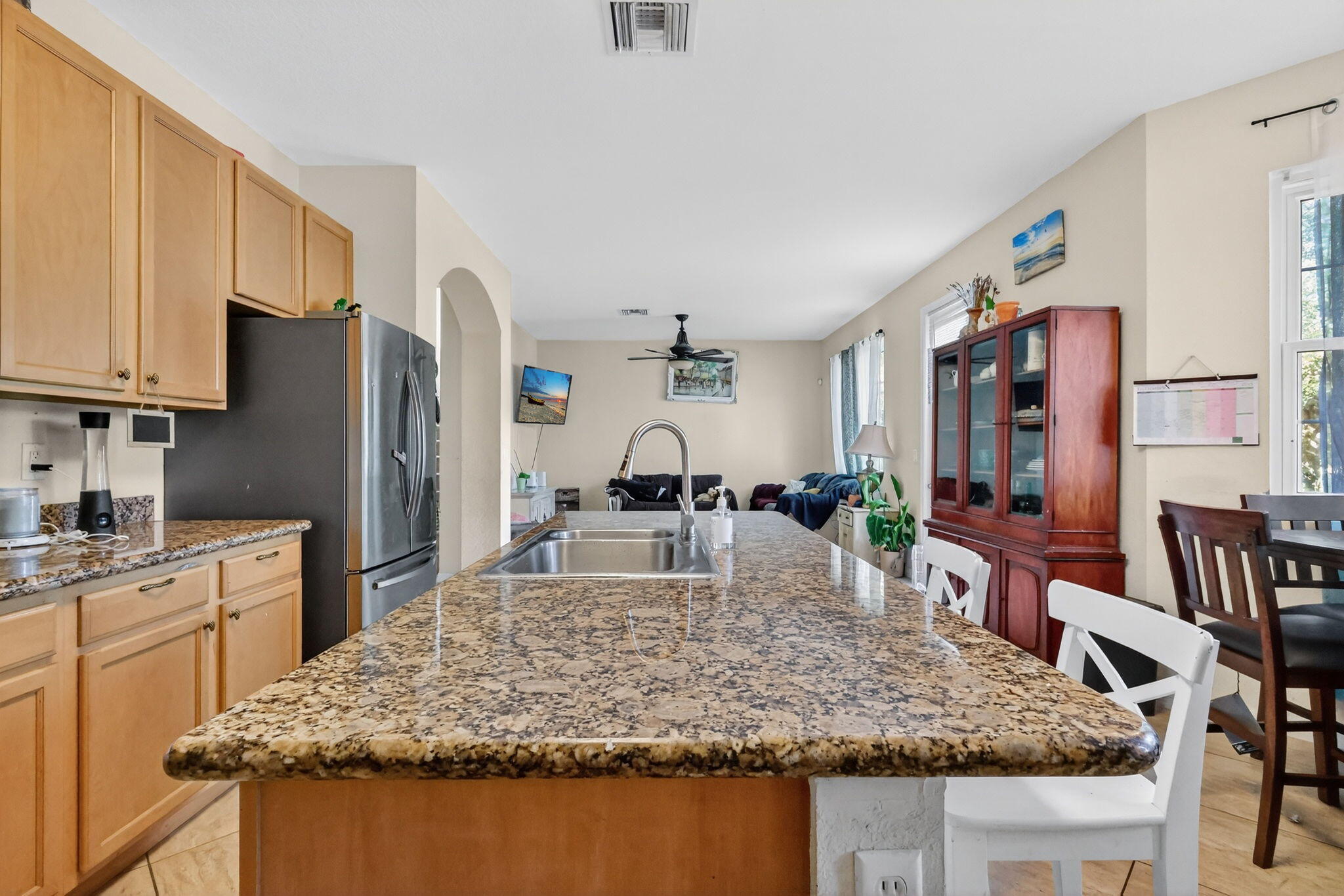 6720 Osage Circle Greenacres, FL 33413 - Photo 19 of 54 a kitchen with stainless steel appliances granite countertop a sink stove and refrigerator