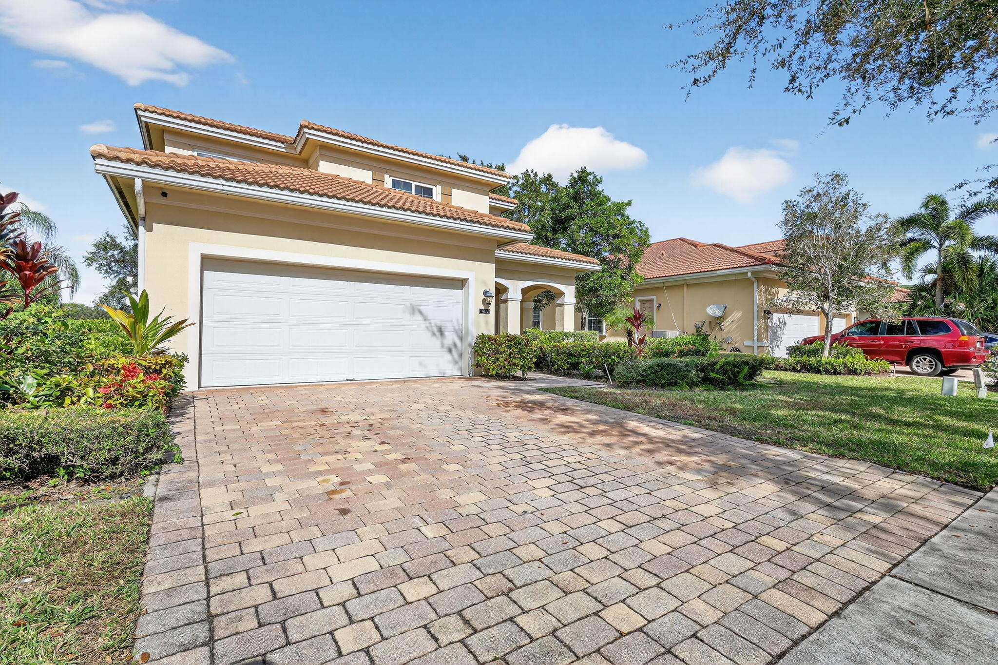 6720 Osage Circle Greenacres, FL 33413 - Photo 2 of 54 a view of a house with a yard and potted plants