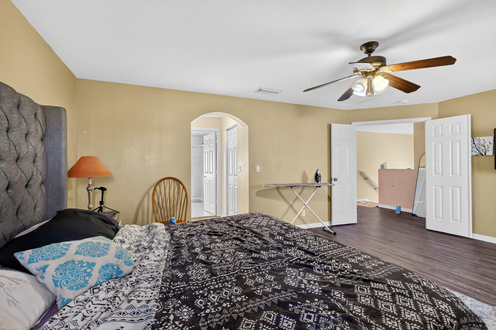 6720 Osage Circle Greenacres, FL 33413 - Photo 22 of 54 a bedroom with a bed and a chandelier