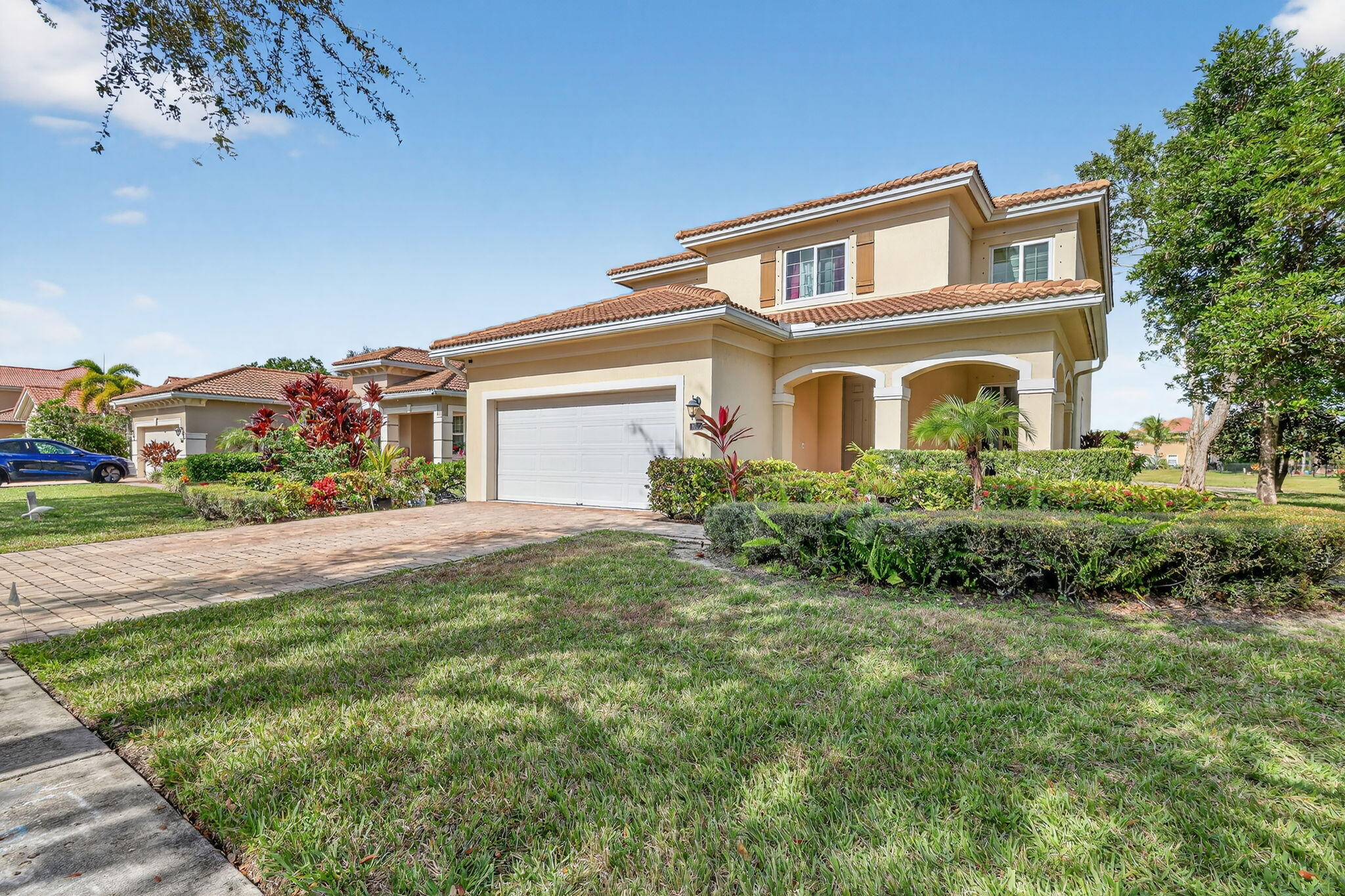 6720 Osage Circle Greenacres, FL 33413 - Photo 3 of 54 a front view of a house with a yard