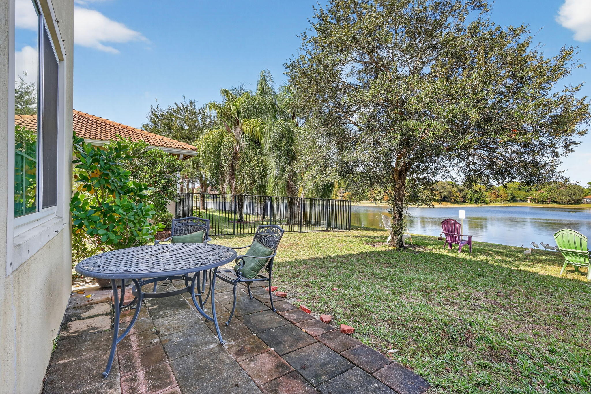 6720 Osage Circle Greenacres, FL 33413 - Photo 35 of 54 a view of a chairs and table in backyard