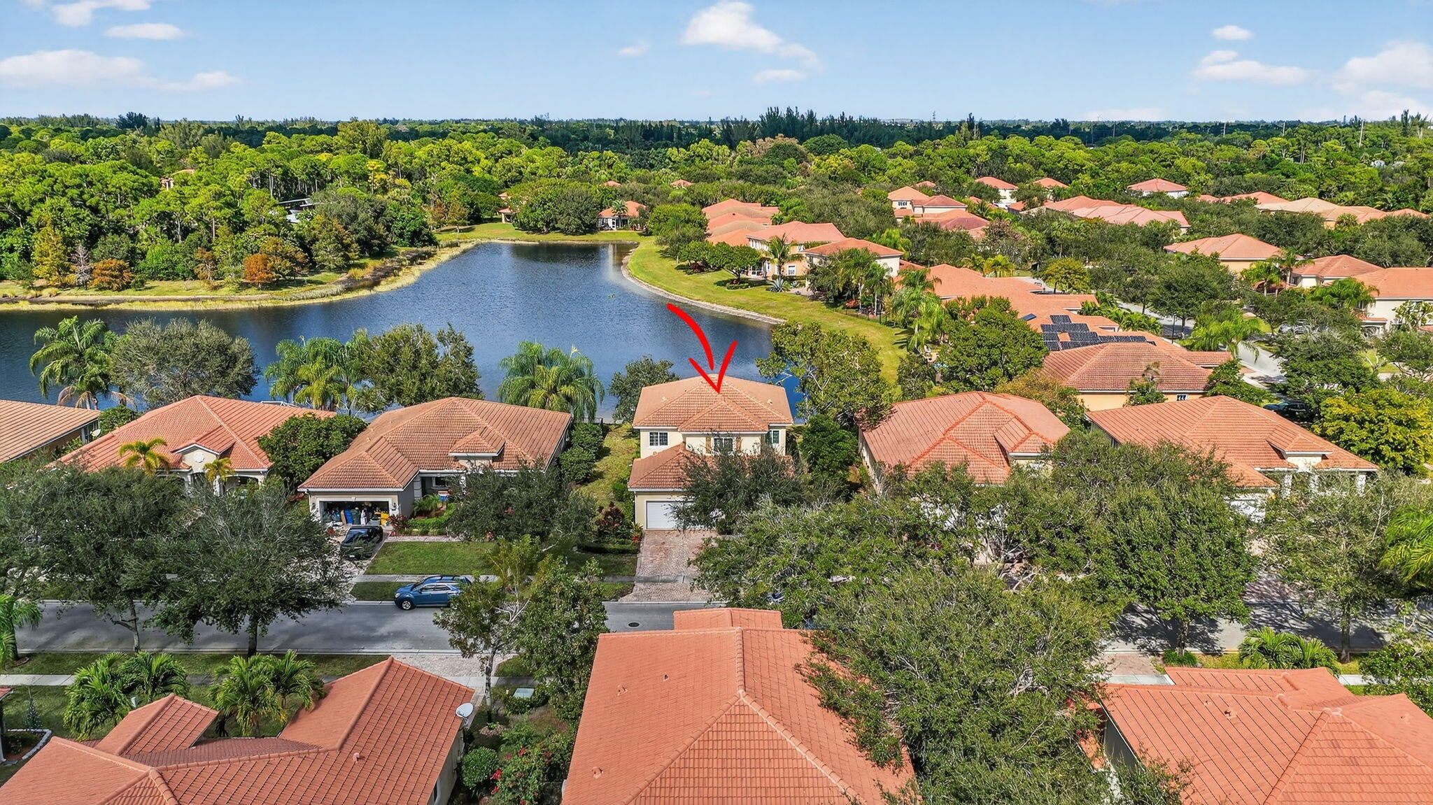 6720 Osage Circle Greenacres, FL 33413 - Photo 40 of 54 an aerial view of a house with a garden and lake view